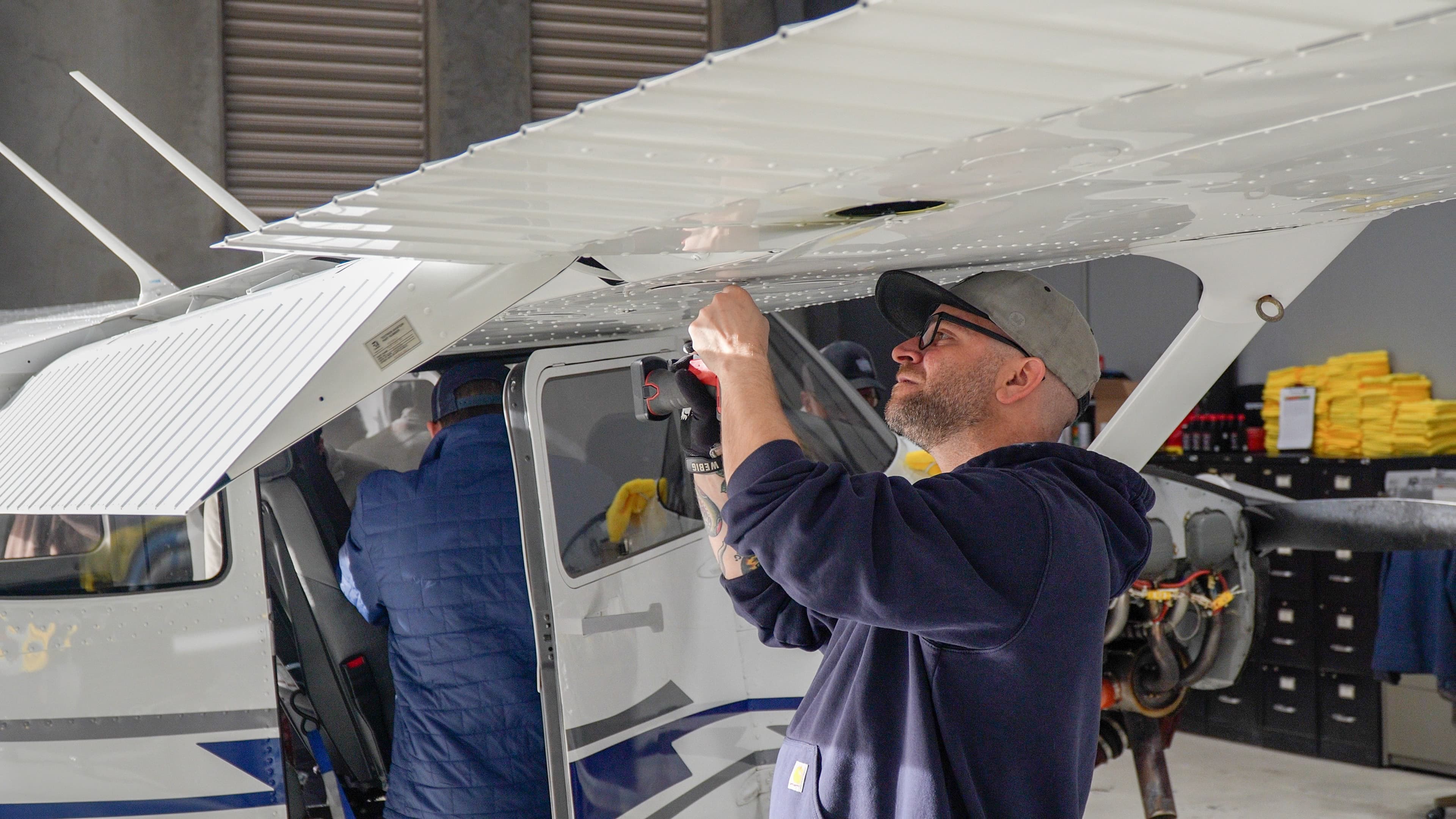 Mechanic inspecting a training aircraft